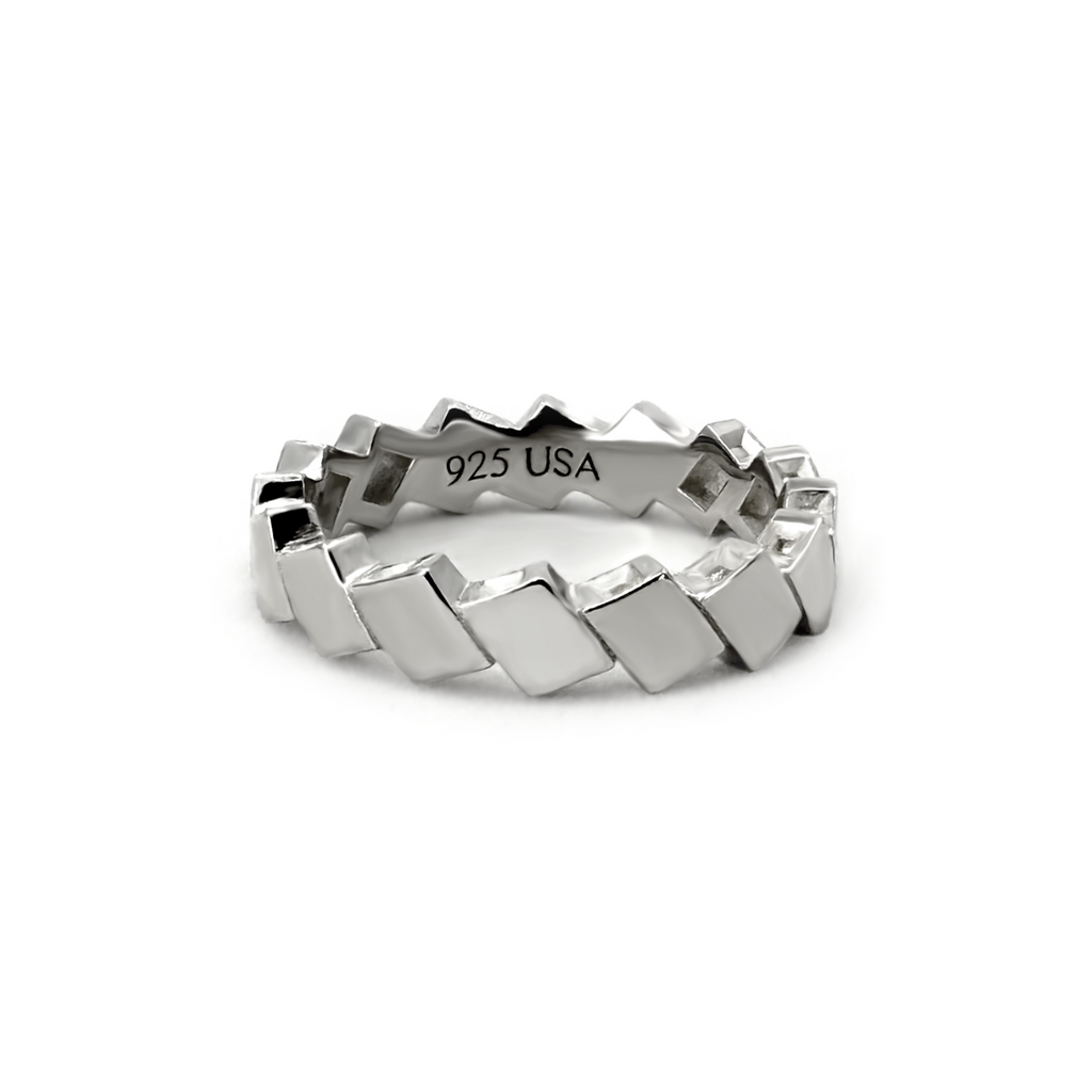 Vela polished silver band with repeating diamond-shaped metal facets.